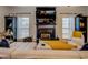 Living room with a fireplace, built-in shelving, and large windows at 2587 Alvecot Cir, Atlanta, GA 30339