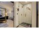 Walk-in shower with marble tile and gold accents at 2587 Alvecot Cir, Atlanta, GA 30339