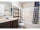 Well lit bathroom with tub and shower combination, dark wood cabinets, and chrome fixtures at 520 Harmony Way, Locust Grove, GA 30248