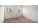 Carpeted bedroom with natural lighting from dual windows at 520 Harmony Way, Locust Grove, GA 30248