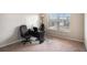 This carpeted bedroom features a window bringing in natural light and has space for a desk or sitting area at 520 Harmony Way, Locust Grove, GA 30248