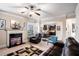 Comfortable living room showcasing a fireplace, a ceiling fan and a view into a bright dining area at 520 Harmony Way, Locust Grove, GA 30248