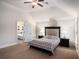 Serene bedroom featuring a vaulted ceiling, carpeted floors, and an ensuite bathroom at 520 Harmony Way, Locust Grove, GA 30248