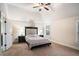 Serene bedroom featuring a vaulted ceiling, carpeted floors and two bedside tables with lamps at 520 Harmony Way, Locust Grove, GA 30248
