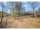 Large backyard with mature trees and grassy area at 4496 Whitt Station Nw Run, Acworth, GA 30101