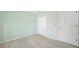 Bedroom with light green walls, wood-look floors, and double doors at 4496 Whitt Station Nw Run, Acworth, GA 30101