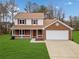 Brick house with a two-car garage and a well-maintained lawn at 4496 Whitt Station Nw Run, Acworth, GA 30101