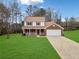 Brick two-story house with a spacious yard and attached garage at 4496 Whitt Station Nw Run, Acworth, GA 30101