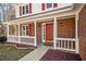 Inviting front porch with red door and white railing at 4496 Whitt Station Nw Run, Acworth, GA 30101