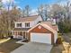 Two-story brick and white sided house with attached garage at 4496 Whitt Station Nw Run, Acworth, GA 30101