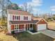 Two-story house with red shutters and attached garage at 4496 Whitt Station Nw Run, Acworth, GA 30101