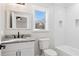 Modern bathroom with white tile and granite countertop at 5068 Maple Dr, Forest Park, GA 30297