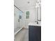 Bathroom featuring a shower, stylish tile, and a dark-colored vanity at 116 Cottage Gate Ln, Roswell, GA 30076
