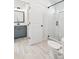 Beautiful bathroom featuring marble tile floor, glass shower, and modern vanity with gray cabinetry at 116 Cottage Gate Ln, Roswell, GA 30076