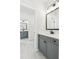 Stylish bathroom with tiled floors, a gray vanity, and updated fixtures at 116 Cottage Gate Ln, Roswell, GA 30076