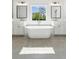 Elegant bathroom with double vanity, soaking tub, and modern finishes at 116 Cottage Gate Ln, Roswell, GA 30076