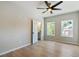 Lovely bedroom featuring hardwood floors, large windows, and a ceiling fan at 116 Cottage Gate Ln, Roswell, GA 30076