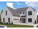 Two-story home with gray brick and a three-car garage at 116 Cottage Gate Ln, Roswell, GA 30076