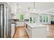 Bright kitchen featuring an island, stainless appliances, and natural light from nearby windows at 116 Cottage Gate Ln, Roswell, GA 30076