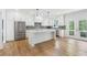 Spacious kitchen featuring white cabinets, stainless steel appliances, and a large island at 116 Cottage Gate Ln, Roswell, GA 30076