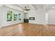 Open-concept living room with a modern fireplace, sleek floors, and bright natural light at 116 Cottage Gate Ln, Roswell, GA 30076