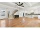Bright and airy open-concept living room with a modern kitchen and hardwood floors at 116 Cottage Gate Ln, Roswell, GA 30076