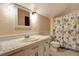 Full bathroom with floral shower curtain and tiled floor at 305 Carrolls Way, Fayetteville, GA 30215