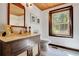 Simple bathroom with a dark wooden vanity and a window at 305 Carrolls Way, Fayetteville, GA 30215