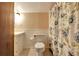 Simple bathroom with floral shower curtain and neutral walls at 305 Carrolls Way, Fayetteville, GA 30215