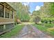 Long driveway leading to a charming log cabin in a wooded area at 305 Carrolls Way, Fayetteville, GA 30215
