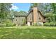 Log cabin home with a large backyard and stone chimney at 305 Carrolls Way, Fayetteville, GA 30215