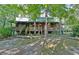Inviting log cabin nestled in a wooded setting, offering a spacious deck at 305 Carrolls Way, Fayetteville, GA 30215