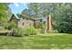 Log cabin home with a green roof and large yard at 305 Carrolls Way, Fayetteville, GA 30215