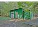 Green metal garage with a white door and large windows at 305 Carrolls Way, Fayetteville, GA 30215