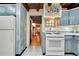 Kitchen with white appliances and light blue cabinets at 305 Carrolls Way, Fayetteville, GA 30215