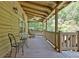 Relaxing wooden porch with rocking chair and a small table at 305 Carrolls Way, Fayetteville, GA 30215