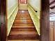 Wooden staircase with yellow painted risers and banister at 305 Carrolls Way, Fayetteville, GA 30215