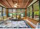 Bright sunroom with wicker furniture, large windows, and wood flooring at 305 Carrolls Way, Fayetteville, GA 30215