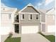 3-story townhome with gray brick exterior, 2-car garage, and landscaping at 663 Cygnet Ln, Grayson, GA 30017