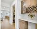 Hallway with wine rack, white countertop, and open access to the living room at 307 Rockledge Sw Bnd, Powder Springs, GA 30127