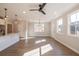 Bright living room with hardwood floors, ceiling fan, and multiple windows at 701 Trevett Way, Marietta, GA 30062