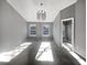 Large bedroom with carpet, two windows, and a walk-in closet at 2891 Vining Ridge Ter, Decatur, GA 30034