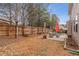 Large backyard with patio, wooden fence, and trees at 1955 Dakota Nw Dr, Acworth, GA 30101