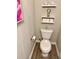 Clean bathroom with toilet and floating shelves for storage at 2786 Laurel Ridge Cir, East Point, GA 30344