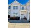 Two-story townhome with white siding, brick accents, and a welcoming front porch at 2786 Laurel Ridge Cir, East Point, GA 30344