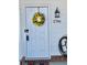 White front door adorned with a sunflower wreath, showcasing curb appeal at 2786 Laurel Ridge Cir, East Point, GA 30344