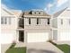 Two-story brick townhome with a neutral color palette and a two-car garage at 643 Cygnet Ln, Grayson, GA 30017