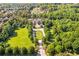 Stunning aerial view of a grand estate showcasing manicured lawns, lush landscaping, and a long driveway at 5200 Moore Rd, Suwanee, GA 30024