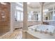Primary bathroom with soaking tub, walk-in shower, and large vanity with white cabinets at 5200 Moore Rd, Suwanee, GA 30024