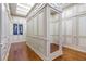 Spacious walk-in closet with custom cabinetry and hardwood floors under a skylight at 5200 Moore Rd, Suwanee, GA 30024